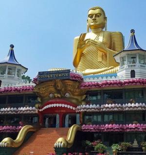 a building with a large golden statue on top of it