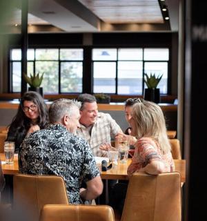 a group of people sitting at a table in a restaurant