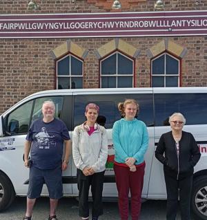a group of people standing in front of a van