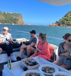 a group of people sitting on a boat in the water