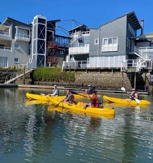a group of people in yellow boats in the water