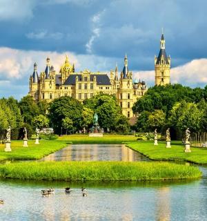 a palace with a pond in front of a building