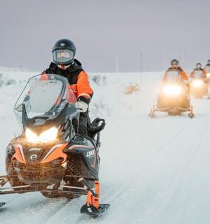 a man is riding a snowmobile in the snow