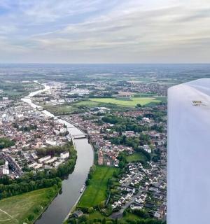 a view from the wing of an airplane flying over a river