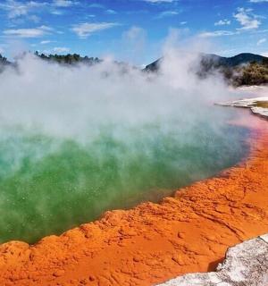a body of water with steam rising from it