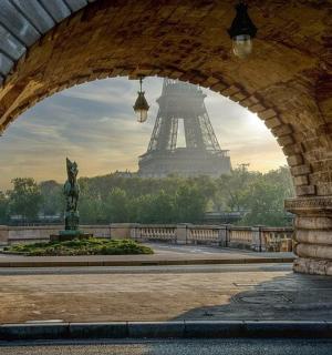 an archway with a view of the eiffel tower
