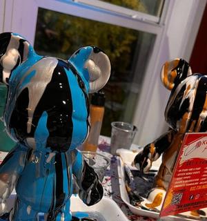 two figurines of dogs sitting on a table