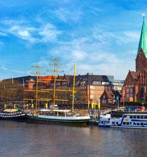 a group of boats docked in a harbor with a church