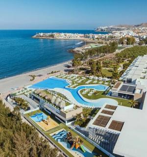 an aerial view of a resort and the ocean