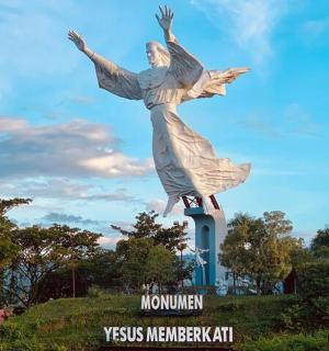 a statue of a woman on top of a hill