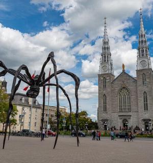 a statue of a spider in front of a church