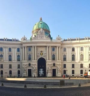 a large white building with green domes on top of it