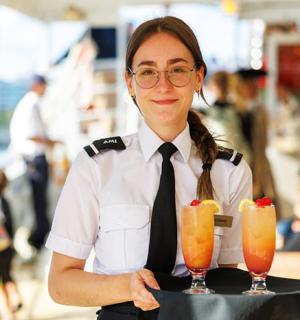 a woman holding a tray with two drinks