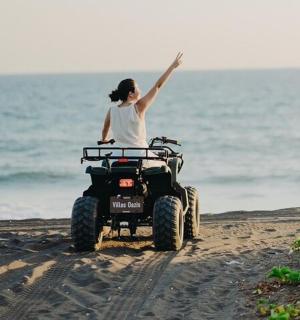 a woman on a wheeler on the beach