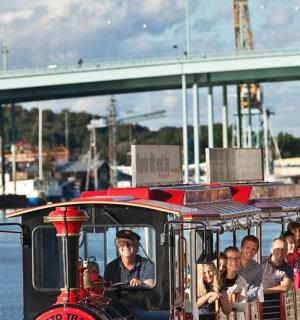 a group of people riding on a small train