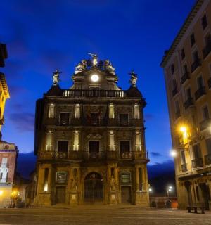 a large building with a clock tower at night