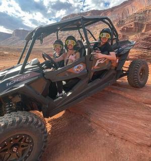 a group of people in a jeep in the desert