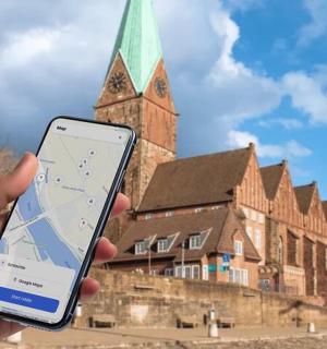 a person holding a cell phone in front of a building