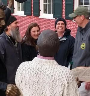 a group of people standing around a man