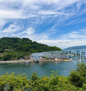 a large bridge over a river with a mountain