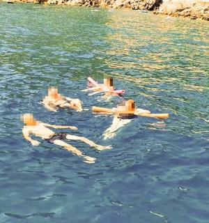 a group of people floating in the water