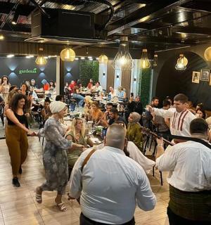 a group of people standing in a room with a crowd