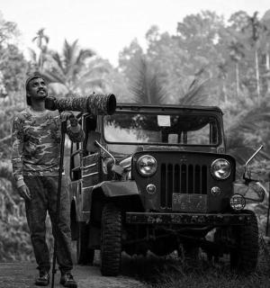 a man is standing next to a jeep