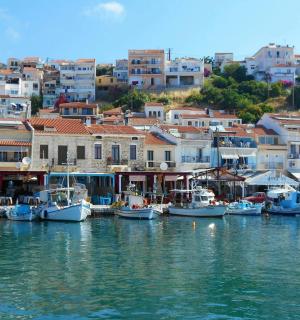 a group of boats docked in a harbor with buildings