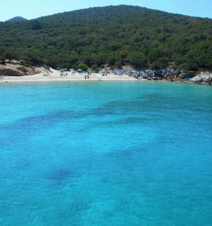 a large body of blue water next to a beach