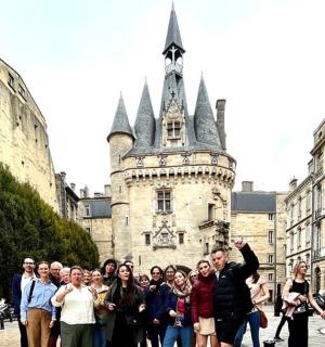 a group of people standing in front of a castle