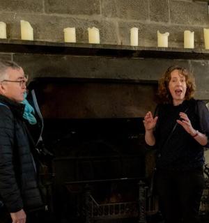 a man and a woman standing in front of a piano