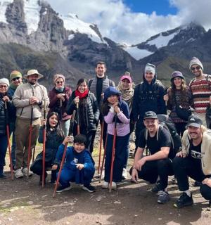a group of people posing for a picture on a mountain