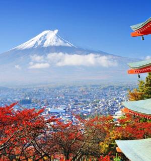 a mountain in the background with buildings and trees