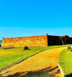 a brick building sitting on top of a lush green field