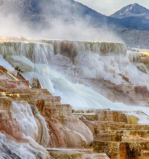a view of a waterfall with snow and ice