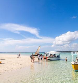 一群人在有船的海滩上