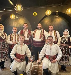 a group of people in traditional costumes posing for a picture