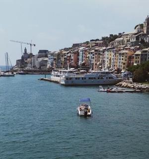 一艘小船在一片有建筑物的广阔水域中