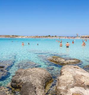 a group of people in the water at the beach