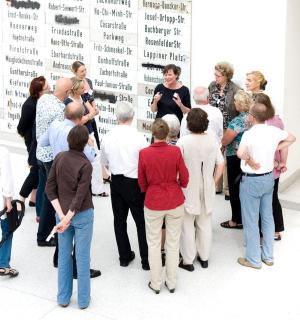 a group of people standing in front of a wall