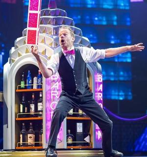 一名男子站在舞台上，张开双臂