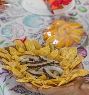 a hand holding a plate of food on a table