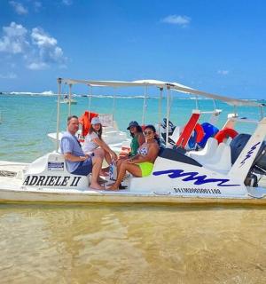 a group of people sitting on a boat on the beach