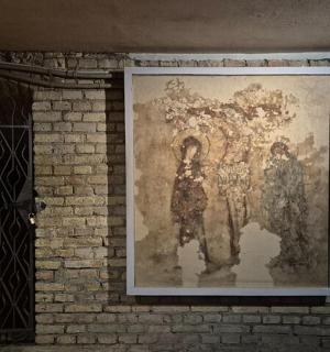 a large painting on a brick wall next to a door