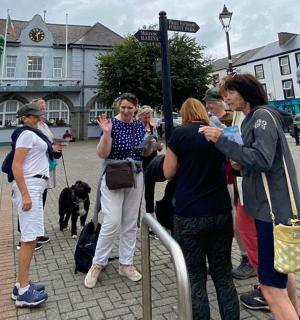 a group of people standing at a bus stop