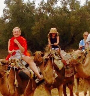 skupina lidí jezdících na koních po nezpevněné cestě