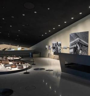 a room with a table and photographs on the wall