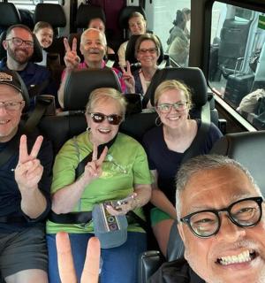 a group of people sitting in a bus