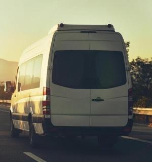 a white van is driving down a highway
