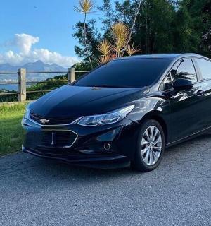 a black car parked on the side of a road